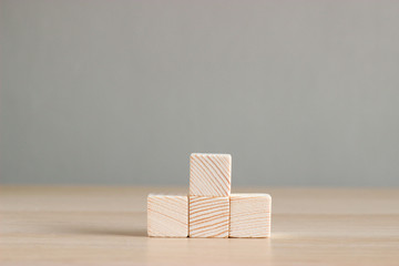wood blocks on wood table with gray background