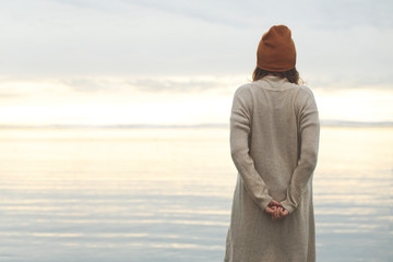 lonely woman looks at the infinite in the hope of a better future