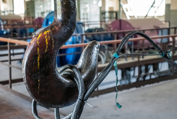 Industry. Metal hook with lifting cable mechanism. Close-up.