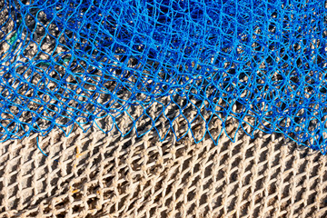 Naklejka premium Commercial beige and blue color fishing nets background