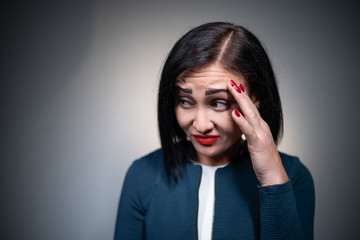 studio shot of brunette female has aggression and disgust