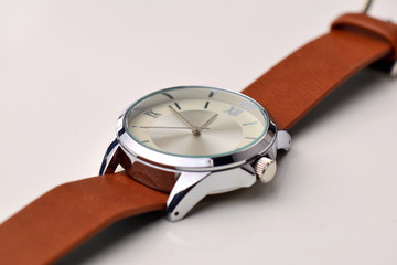 Silver wrist watch with a brown single-piece leather strap. Double-sided nato strap. White...