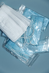 Obraz premium Surgical mask with rubber straps. A three-layer surgical mask for covering the mouth and nose. Bacterial mask procedure. Concept of protection.