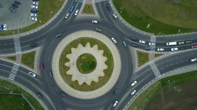 Aerial photography of a roundabout intersection with heavy traffic in summer