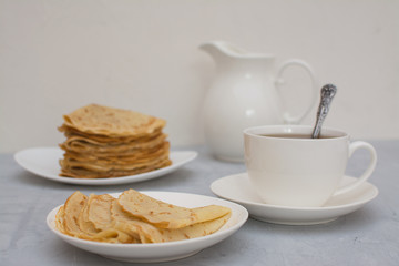 Homemade, thin, Russian pancakes with sour cream for breakfast.