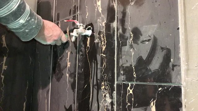 Installing and tightening shower faucet bung in 4k  with black marble tracery bathroom tiles