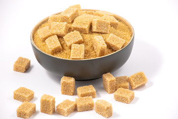 Brown sugar in a wooden bowl or wooden spoon Sugar for health Use for cooking or desserts on white and sugar backgrounds.