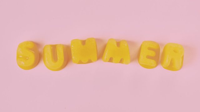 Stop motion animation video of melting yellow letters made of ice says summer