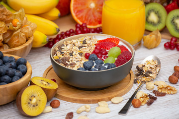 Group Fruits Breakfast mixed vegetables with salad bowl, nuts bowl, strawberry, banana, and pineapple, orange juice,  vitamin c in food  nature for health and diet in the top view on the wood table.