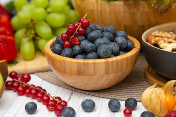 Group Fruits Breakfast mixed vegetables with salad bowl, nuts bowl, strawberry, banana, and pineapple, orange juice,  vitamin c in food  nature for health and diet in the top view on the wood table.