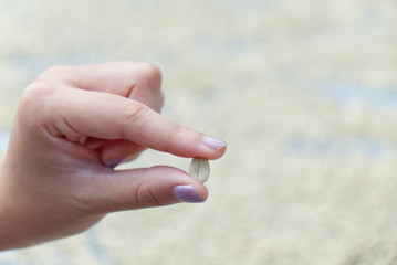 Girl Holding Raw Robusta Cherry Coffee Beans with Drying on the Table Background.