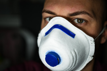 boy with green eyes and with a mask to avoid contagion from the Coronavirus COVID-19