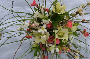 Bouquet of delicate flowers of snowdrops, hellebore and young cherry. flowers