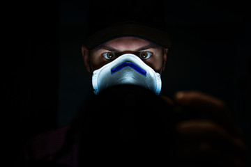 boy with green eyes and with a mask to avoid contagion from the Coronavirus COVID-19