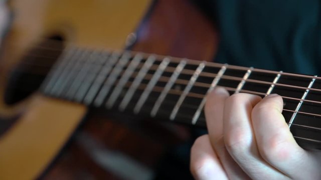 a man playing acustic guitar