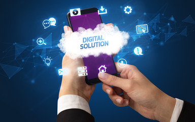 Obraz premium Female hand holding smartphone with DIGITAL SOLUTION inscription, cloud technology concept
