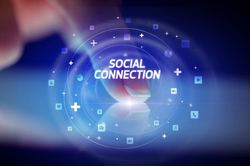 Finger touching tablet with social media icons and SOCIAL CONNECTION
