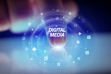Finger touching tablet with social media icons and DIGITAL MEDIA