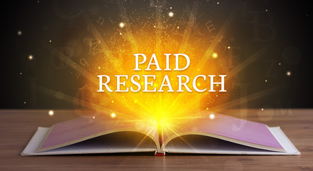 PAID RESEARCH inscription coming out from an open book, educational concept