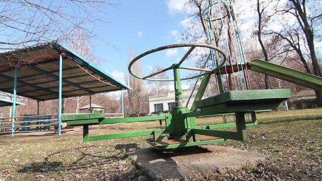Old Merry-Go-Round Spinning In Eastern European Orphanage Playground