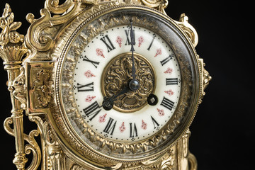 Fototapeta na wymiar dial of vintage bronze clock, antique clock photo close up, old bronze clock in gilding, eight o'clock on the dial, 8 am on the clock face, 8 pm hours on the dial