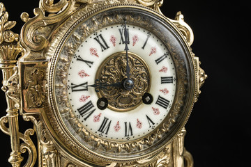 dial of vintage bronze clock, antique clock photo close up, old bronze clock in gilding, nine o'clock on the dial, 9 am on the clock face, 9 pm hours on the dial