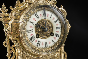 Fototapeta na wymiar dial of vintage bronze clock, antique clock photo close up, old bronze clock in gilding, ten o'clock on the dial, 10 am on the clock face, 10 pm hours on the dial