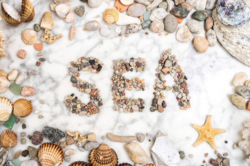inscription sea with pebbles, photo frame of seashells and pebbles, composition of sea stones and seashells, word sea written from pebbles, sea word written with stones