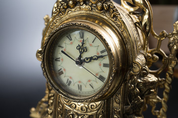 dial of vintage bronze clock, antique clock photo close up, old bronze clock in gilding, front of...