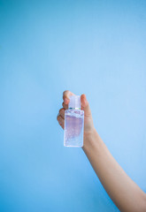 one women hand  is carrying alcohol gel for washing hands to protect against covic 19 virus.