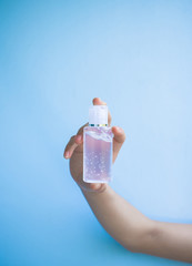 one women hand  is carrying alcohol gel for washing hands to protect against covic 19 virus.