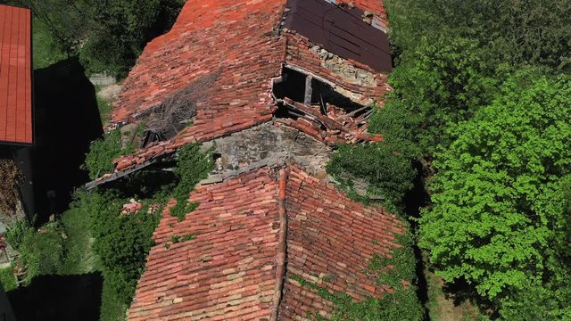 Aerial Over Overgrown Abandoned Building With Broken Roof Tiles, Slapnik, Slovenia