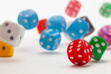 Playing dice at white wooden background.