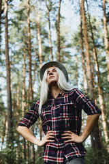 Portrait of  young adult female walking in the forest, selective focus