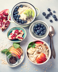 Bowls of oatmeal with berries and fruits  for healthy breakfast. Food with vitamins, minerals and antioxidants. Top view
