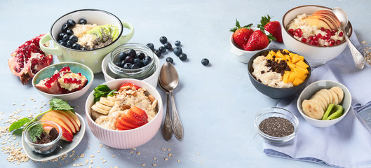 Bowls of oatmeal with berries and fruits  for healthy breakfast. Food with vitamins, minerals and antioxidants. Image with copy space