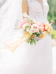 Beautiful wedding bouquet in hands of the bride. Just married wedding couple posing and bride...