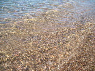 Scenic shining view of the clear water of the Red Sea on a sunny summer day. Colorful natural fresh background for creative illustration with shiny blur effect. Bright sea scape beauty.
