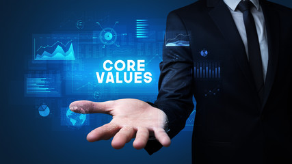 Hand of Businessman holding CORE VALUES inscription, business success concept