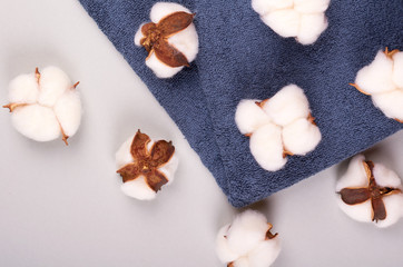 Spa concept idea, cotton and towel composition on grey background.