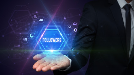 Man hand holding FOLLOWERS inscription, social media concept