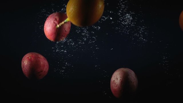 Falling group of maracuya in the water with bubbles