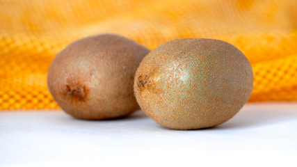 Fototapeta premium Kiwi with peel on yellow and white background_