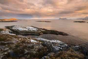 Fototapeta na wymiar An early morning seascape photographed at sunrise in the small fishing village of Sommaroy, Norway.