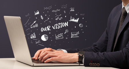 Businessman working on laptop with OUR VISION inscription, modern business concept