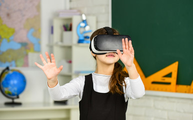 schoolchild using virtual reality. virtual reality headset. teenage schoolgirl in classroom. back to school. In a Computer Science Class. Works on a Programing Project. vr technology