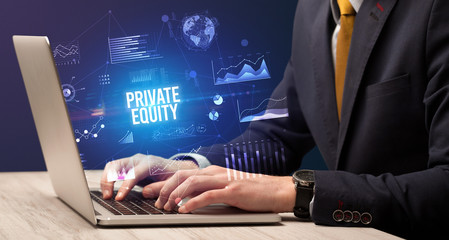 Businessman working on laptop with PRIVATE EQUITY inscription, new business concept