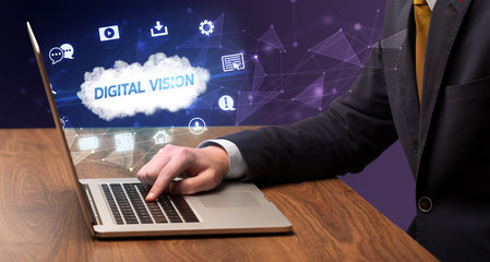 Businessman working on laptop with DIGITAL VISION inscription, modern technology concept