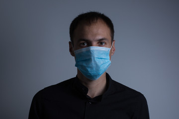Strong man wearing mask to prevent flu virus and dust air pollution on white background