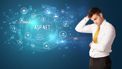 Businessman thinking in front of technology related icons and ASP.NET inscription, modern technology concept